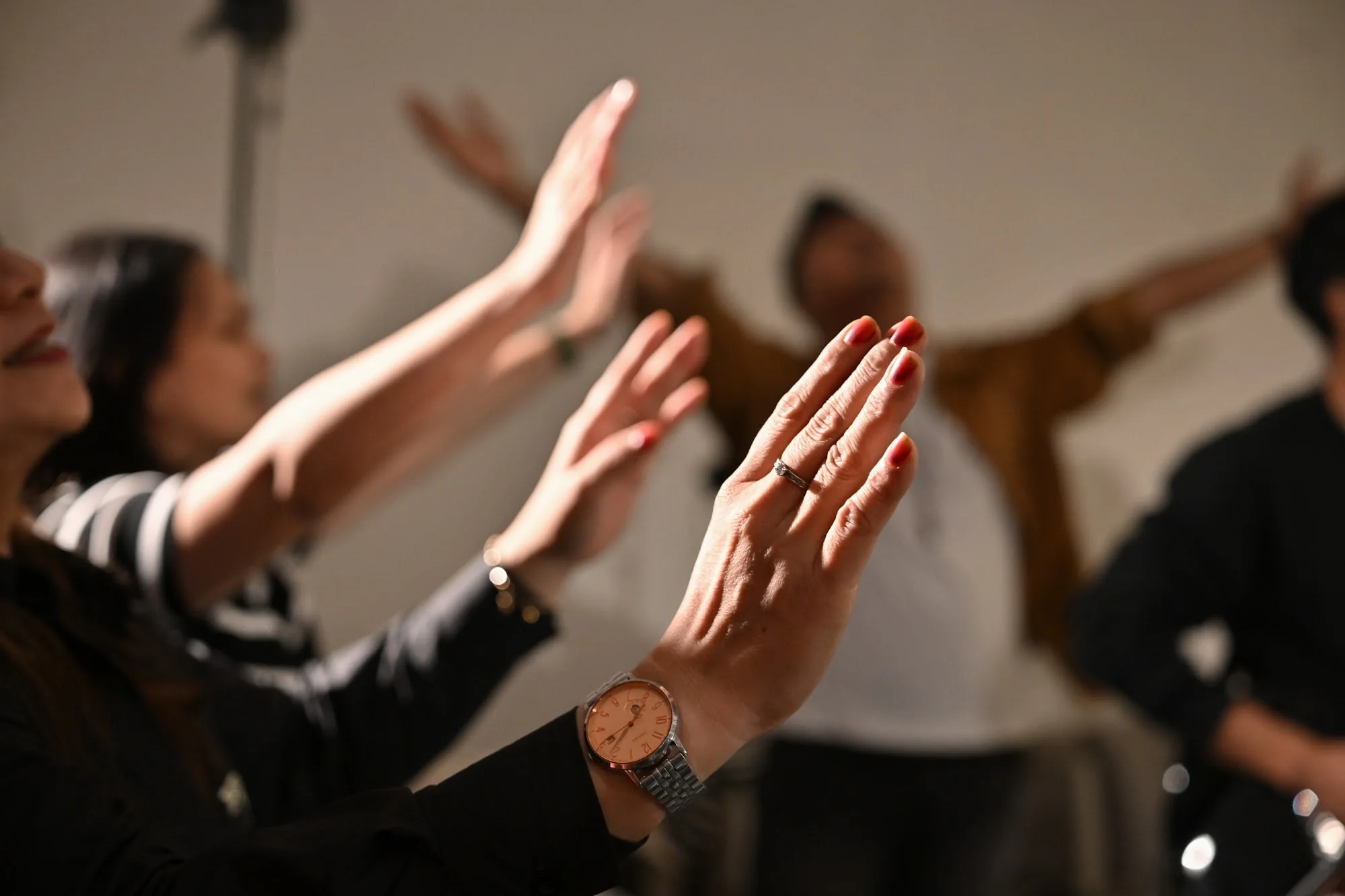 People lift their hands together during worship at City Soul Vol. 2