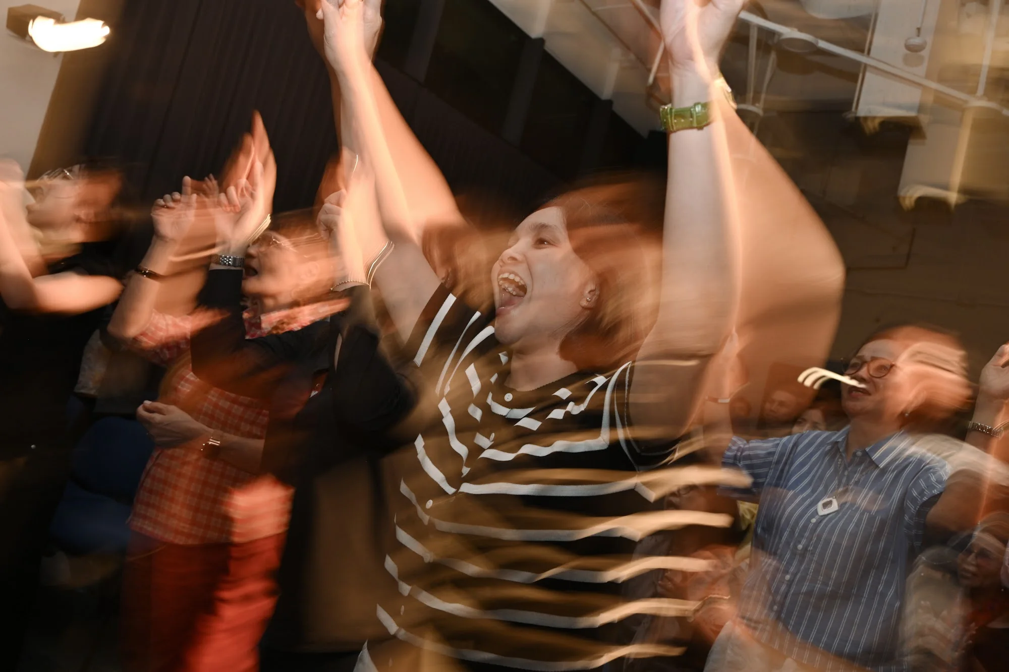 Worshippers sing with raised hands, captured with movement during City Soul Vol. 2
