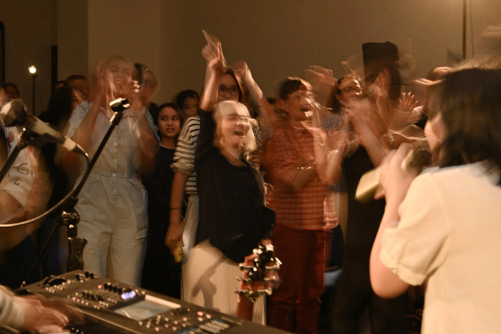 A worship leader sings as the City Soul Vol. 2 community joins behind her