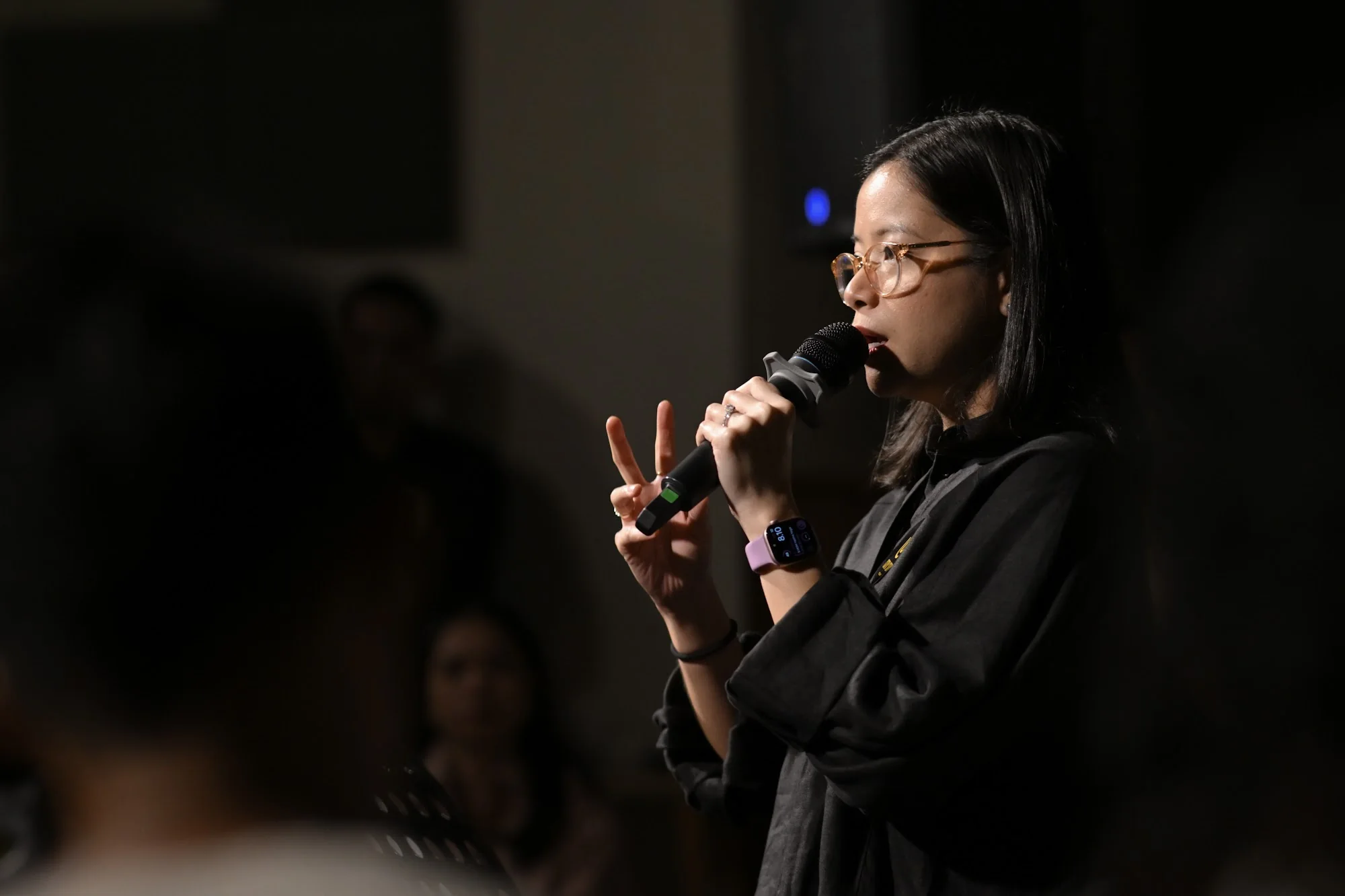 A woman speaks into a microphone during the City Soul Vol. 3 gathering