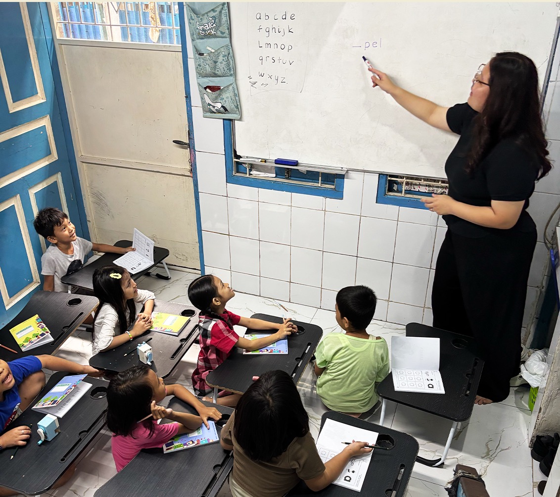 A teacher leading a lesson for children at the YSBM learning house
